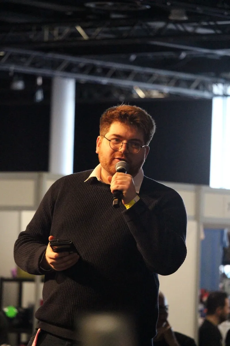 Callum Janes on stage with microphone